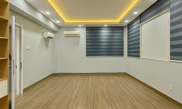 Exterior of a modern 3-storey, 6-bedroom villa for rent in An Phu, District 2 (HCMC), featuring a large garage entrance.