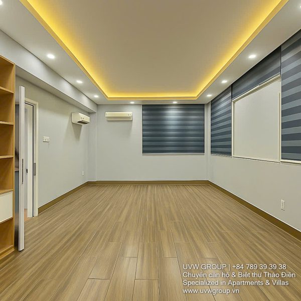 Exterior of a modern 3-storey, 6-bedroom villa for rent in An Phu, District 2 (HCMC), featuring a large garage entrance.