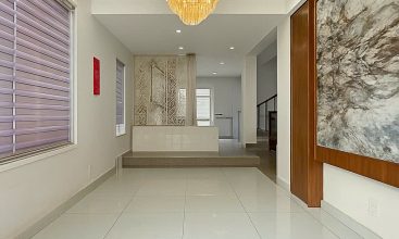 Exterior of a modern 3-storey, 6-bedroom villa for rent in An Phu, District 2 (HCMC), featuring a large garage entrance.