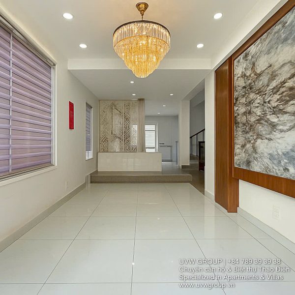 Exterior of a modern 3-storey, 6-bedroom villa for rent in An Phu, District 2 (HCMC), featuring a large garage entrance.