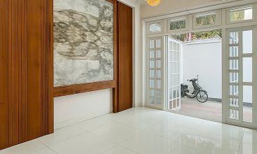 Exterior of a modern 3-storey, 6-bedroom villa for rent in An Phu, District 2 (HCMC), featuring a large garage entrance.