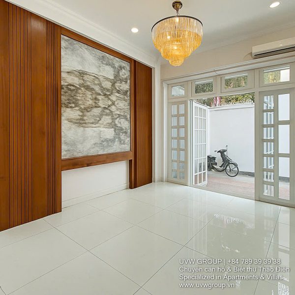 Exterior of a modern 3-storey, 6-bedroom villa for rent in An Phu, District 2 (HCMC), featuring a large garage entrance.