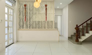 Exterior of a modern 3-storey, 6-bedroom villa for rent in An Phu, District 2 (HCMC), featuring a large garage entrance.