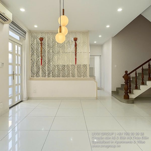 Exterior of a modern 3-storey, 6-bedroom villa for rent in An Phu, District 2 (HCMC), featuring a large garage entrance.