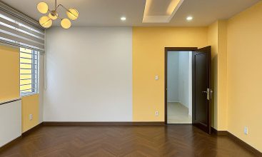 Exterior of a modern 3-storey, 6-bedroom villa for rent in An Phu, District 2 (HCMC), featuring a large garage entrance.
