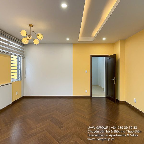 Exterior of a modern 3-storey, 6-bedroom villa for rent in An Phu, District 2 (HCMC), featuring a large garage entrance.