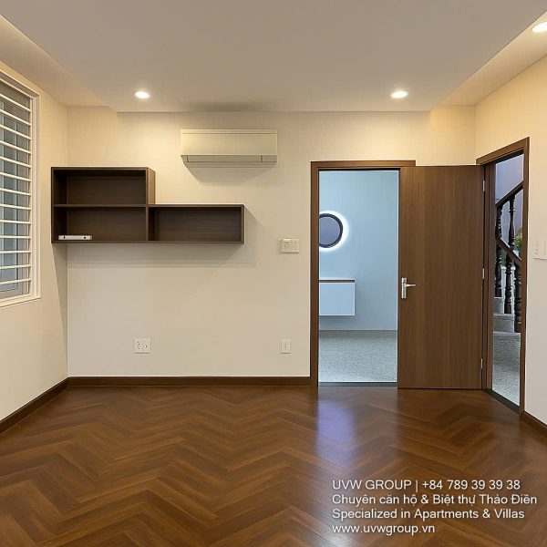 Exterior of a modern 3-storey, 6-bedroom villa for rent in An Phu, District 2 (HCMC), featuring a large garage entrance.