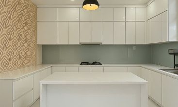 Exterior of a modern 3-storey, 6-bedroom villa for rent in An Phu, District 2 (HCMC), featuring a large garage entrance.