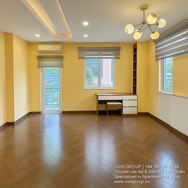 Exterior of a modern 3-storey, 6-bedroom villa for rent in An Phu, District 2 (HCMC), featuring a large garage entrance.