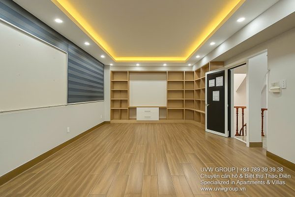 Exterior of a modern 3-storey, 6-bedroom villa for rent in An Phu, District 2 (HCMC), featuring a large garage entrance.
