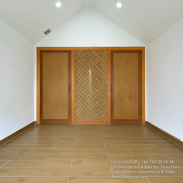 Exterior of a modern 3-storey, 6-bedroom villa for rent in An Phu, District 2 (HCMC), featuring a large garage entrance.