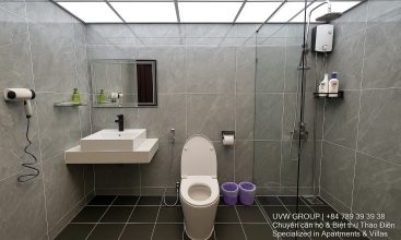 Exterior view of a spacious luxury 7-bedroom villa in Thao Dien, Ho Chi Minh City, featuring a large semi-indoor swimming pool, an elegant living room, a vibrant karaoke lounge with colorful lights, a comfortable king-size bedroom, and modern bathrooms (5 indoor, 3 outdoor).