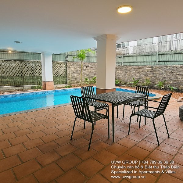 Exterior view of a spacious luxury 7-bedroom villa in Thao Dien, Ho Chi Minh City, featuring a large semi-indoor swimming pool, an elegant living room, a vibrant karaoke lounge with colorful lights, a comfortable king-size bedroom, and modern bathrooms (5 indoor, 3 outdoor).