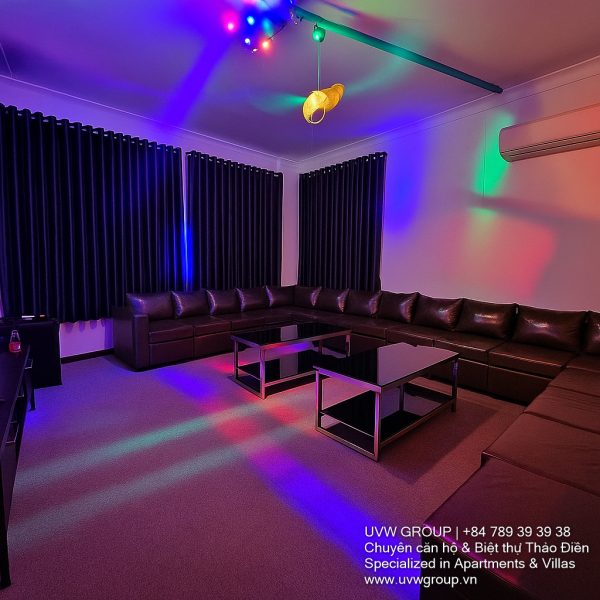Exterior view of a spacious luxury 7-bedroom villa in Thao Dien, Ho Chi Minh City, featuring a large semi-indoor swimming pool, an elegant living room, a vibrant karaoke lounge with colorful lights, a comfortable king-size bedroom, and modern bathrooms (5 indoor, 3 outdoor).