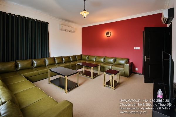 Exterior view of a spacious luxury 7-bedroom villa in Thao Dien, Ho Chi Minh City, featuring a large semi-indoor swimming pool, an elegant living room, a vibrant karaoke lounge with colorful lights, a comfortable king-size bedroom, and modern bathrooms (5 indoor, 3 outdoor).