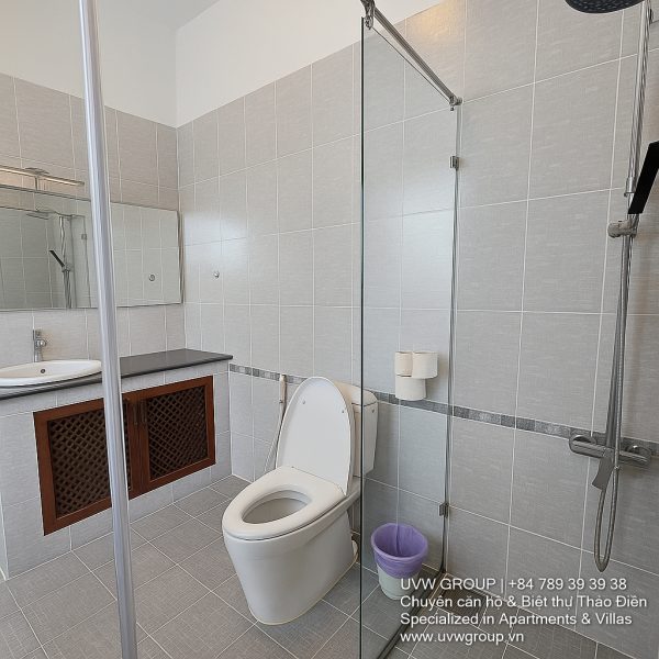 Exterior view of a spacious luxury 7-bedroom villa in Thao Dien, Ho Chi Minh City, featuring a large semi-indoor swimming pool, an elegant living room, a vibrant karaoke lounge with colorful lights, a comfortable king-size bedroom, and modern bathrooms (5 indoor, 3 outdoor).