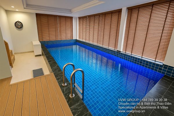 Image of a stunning luxury 4-bedroom villa for short-term rent in Ho Chi Minh City, showcasing its private indoor swimming pool and stylish, fully furnished resort-style interiors.