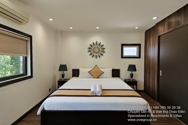 Exterior and interior views of a modern luxury 5-bedroom villa for rent in Thao Dien, Ho Chi Minh City, featuring a unique indoor swimming pool with wooden deck, a stylish living room, a dedicated karaoke room, a king-size bedroom, and 6 contemporary bathrooms (4 indoor, 2 outdoor).