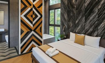 Exterior and interior views of a modern luxury 5-bedroom villa for rent in Thao Dien, Ho Chi Minh City, featuring a unique indoor swimming pool with wooden deck, a stylish living room, a dedicated karaoke room, a king-size bedroom, and 6 contemporary bathrooms (4 indoor, 2 outdoor).