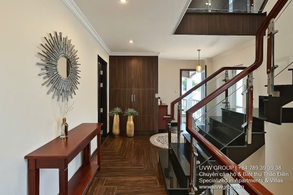 Exterior and interior views of a modern luxury 5-bedroom villa for rent in Thao Dien, Ho Chi Minh City, featuring a unique indoor swimming pool with wooden deck, a stylish living room, a dedicated karaoke room, a king-size bedroom, and 6 contemporary bathrooms (4 indoor, 2 outdoor).