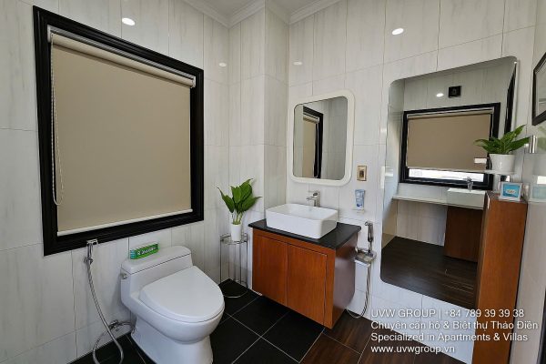 Exterior and interior views of a modern luxury 5-bedroom villa for rent in Thao Dien, Ho Chi Minh City, featuring a unique indoor swimming pool with wooden deck, a stylish living room, a dedicated karaoke room, a king-size bedroom, and 6 contemporary bathrooms (4 indoor, 2 outdoor).