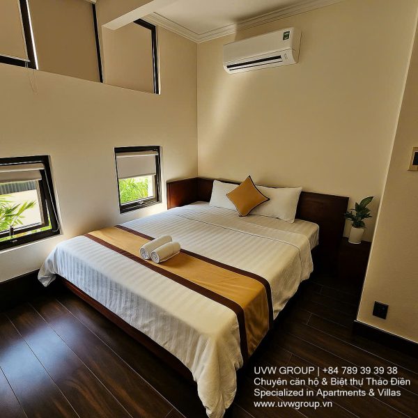 Exterior and interior views of a modern luxury 5-bedroom villa for rent in Thao Dien, Ho Chi Minh City, featuring a unique indoor swimming pool with wooden deck, a stylish living room, a dedicated karaoke room, a king-size bedroom, and 6 contemporary bathrooms (4 indoor, 2 outdoor).