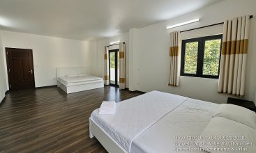 Front view of a 5-bedroom luxury villa with private indoor swimming pool, king-size beds, karaoke room, and modern interiors for short-term rent in Thao Dien, District 2, Ho Chi Minh City.