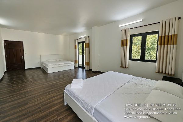 Front view of a 5-bedroom luxury villa with private indoor swimming pool, king-size beds, karaoke room, and modern interiors for short-term rent in Thao Dien, District 2, Ho Chi Minh City.