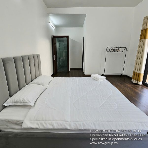 Front view of a 5-bedroom luxury villa with private indoor swimming pool, king-size beds, karaoke room, and modern interiors for short-term rent in Thao Dien, District 2, Ho Chi Minh City.