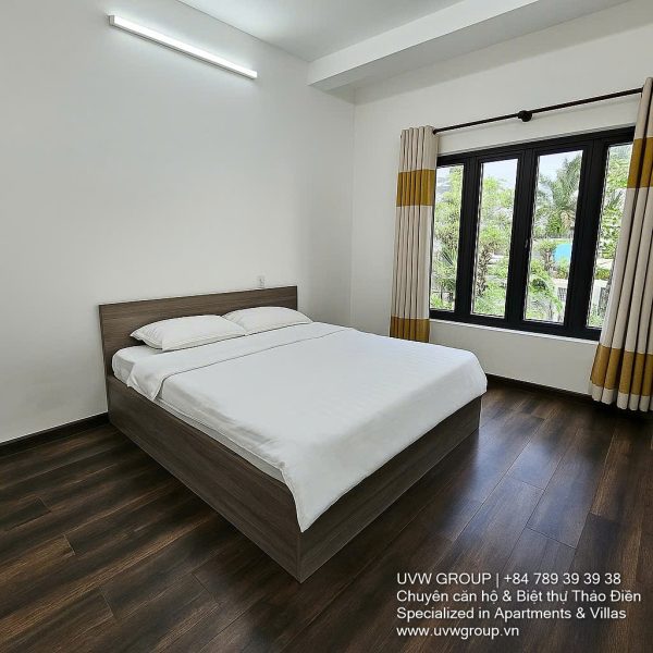 Front view of a 5-bedroom luxury villa with private indoor swimming pool, king-size beds, karaoke room, and modern interiors for short-term rent in Thao Dien, District 2, Ho Chi Minh City.