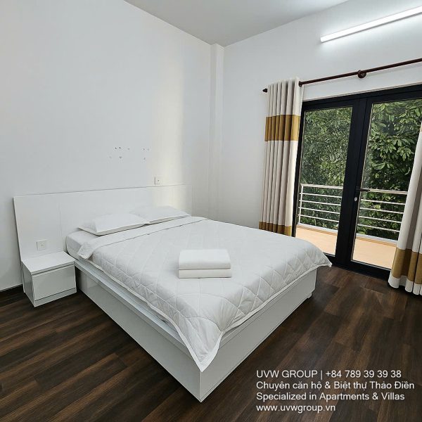 Front view of a 5-bedroom luxury villa with private indoor swimming pool, king-size beds, karaoke room, and modern interiors for short-term rent in Thao Dien, District 2, Ho Chi Minh City.