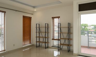 Exterior view of a spacious 3-storey house available for rent in Thao Dien, Ho Chi Minh City, featuring front garden space and traditional tiled roof.