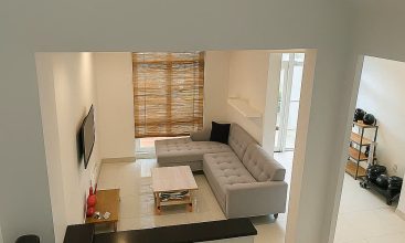 Exterior view of a spacious 3-storey house available for rent in Thao Dien, Ho Chi Minh City, featuring front garden space and traditional tiled roof.
