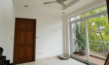 Exterior view of a spacious 3-storey house available for rent in Thao Dien, Ho Chi Minh City, featuring front garden space and traditional tiled roof.
