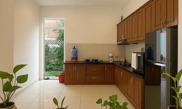 Exterior view of a spacious 3-storey house available for rent in Thao Dien, Ho Chi Minh City, featuring front garden space and traditional tiled roof.