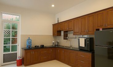 Exterior view of a spacious 3-storey house available for rent in Thao Dien, Ho Chi Minh City, featuring front garden space and traditional tiled roof.
