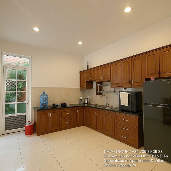 Exterior view of a spacious 3-storey house available for rent in Thao Dien, Ho Chi Minh City, featuring front garden space and traditional tiled roof.
