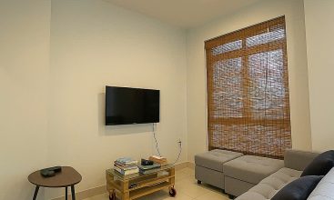 Exterior view of a spacious 3-storey house available for rent in Thao Dien, Ho Chi Minh City, featuring front garden space and traditional tiled roof.